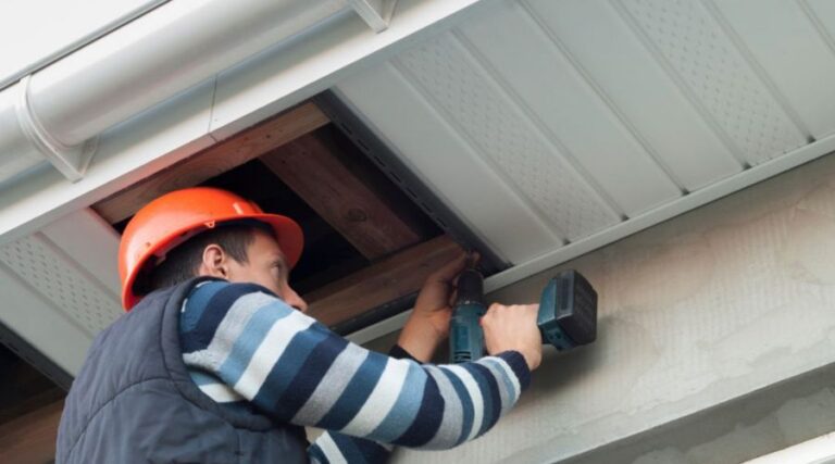 Couvreur en train d'installer des soffites de ventilation sur le toit